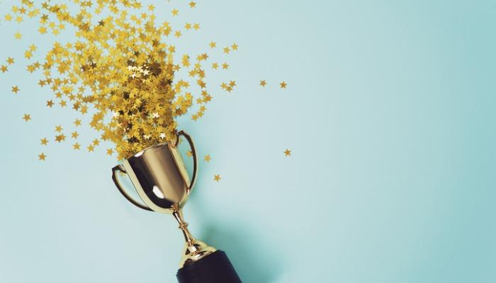 gold-winner-cup-on-blue-background-picture-id1015887056